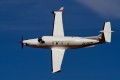 A Pilatus PC-12 of the South African Red Cross flies a sharp left turn.